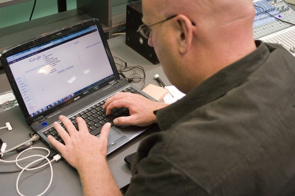 Someone searching on a laptop